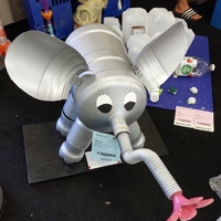 A gray elephant sculpture made using recycled plastic materials.