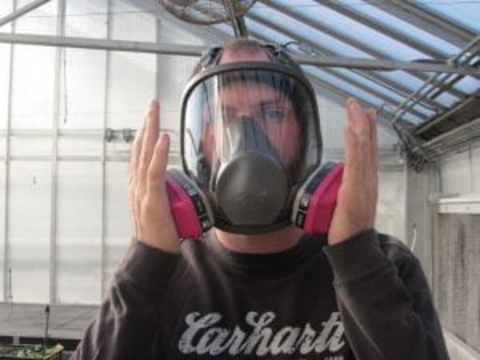 Man wearing a respirator with full face covering.