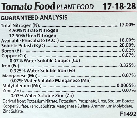 Close up of label on tomato plant food of the guaranteed analysis that shows 17% total nitrogen, 18% available phosphate and 28% soluble potash as the main components. With breakdowns for other micronutrients.