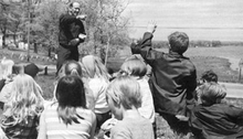Man giving presentation to a group of children