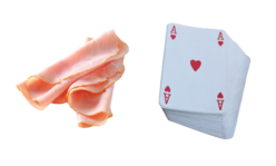 Slices of meat and deck of cards symbolizing a portion