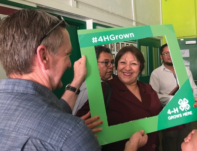 Alma Rodriguez framed with 4-H Grown sign