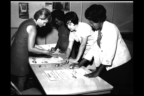 historical black and white image women making nutrition posters