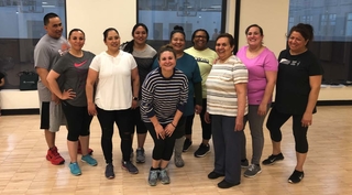 A group of adults who participated in the ICPD program in workout clothes at the YMCA. 