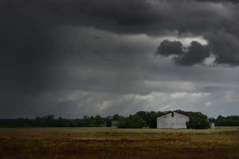 Storm clouds over a farm field