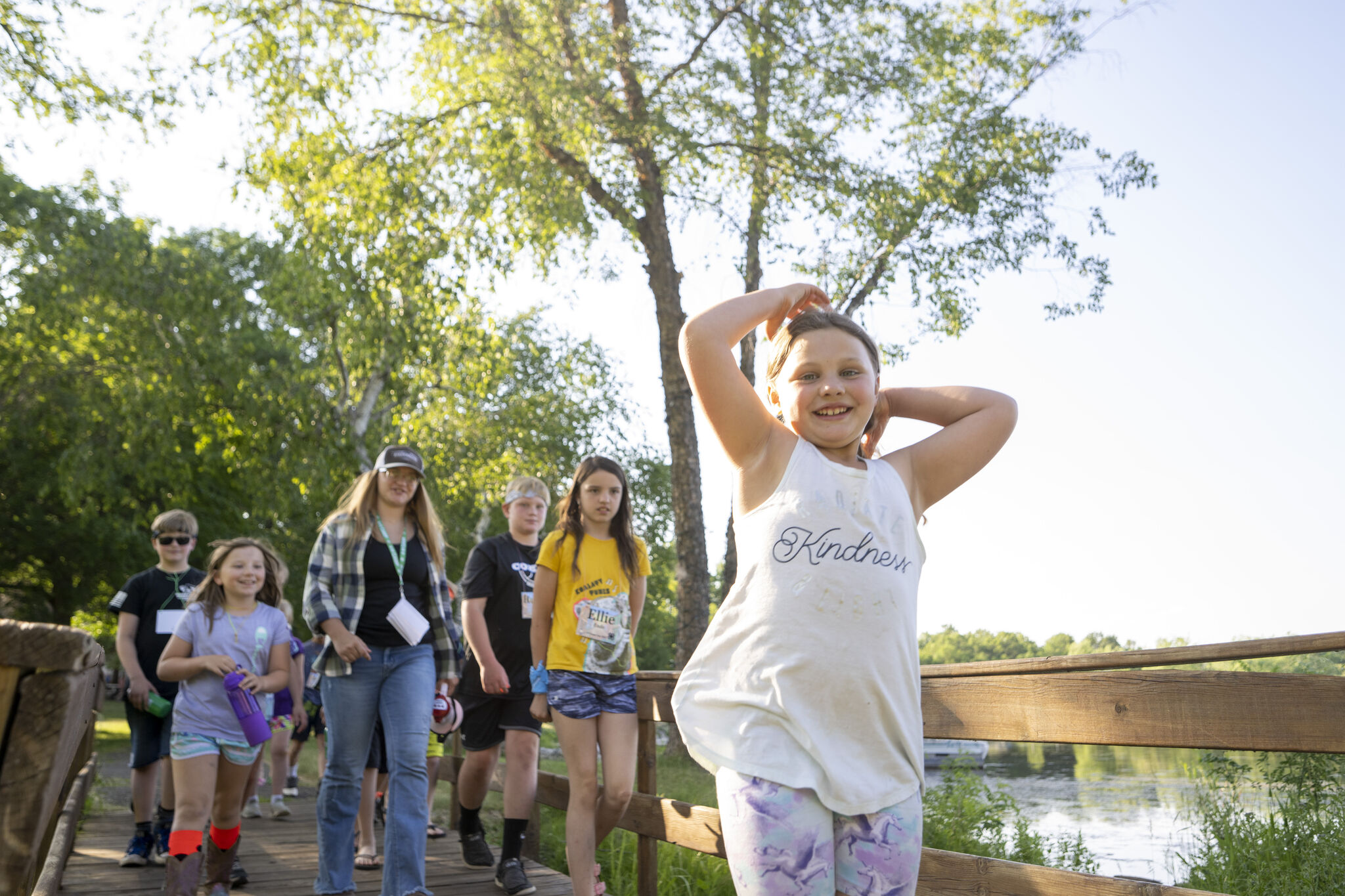 A group of youth campers walking across a bridge.