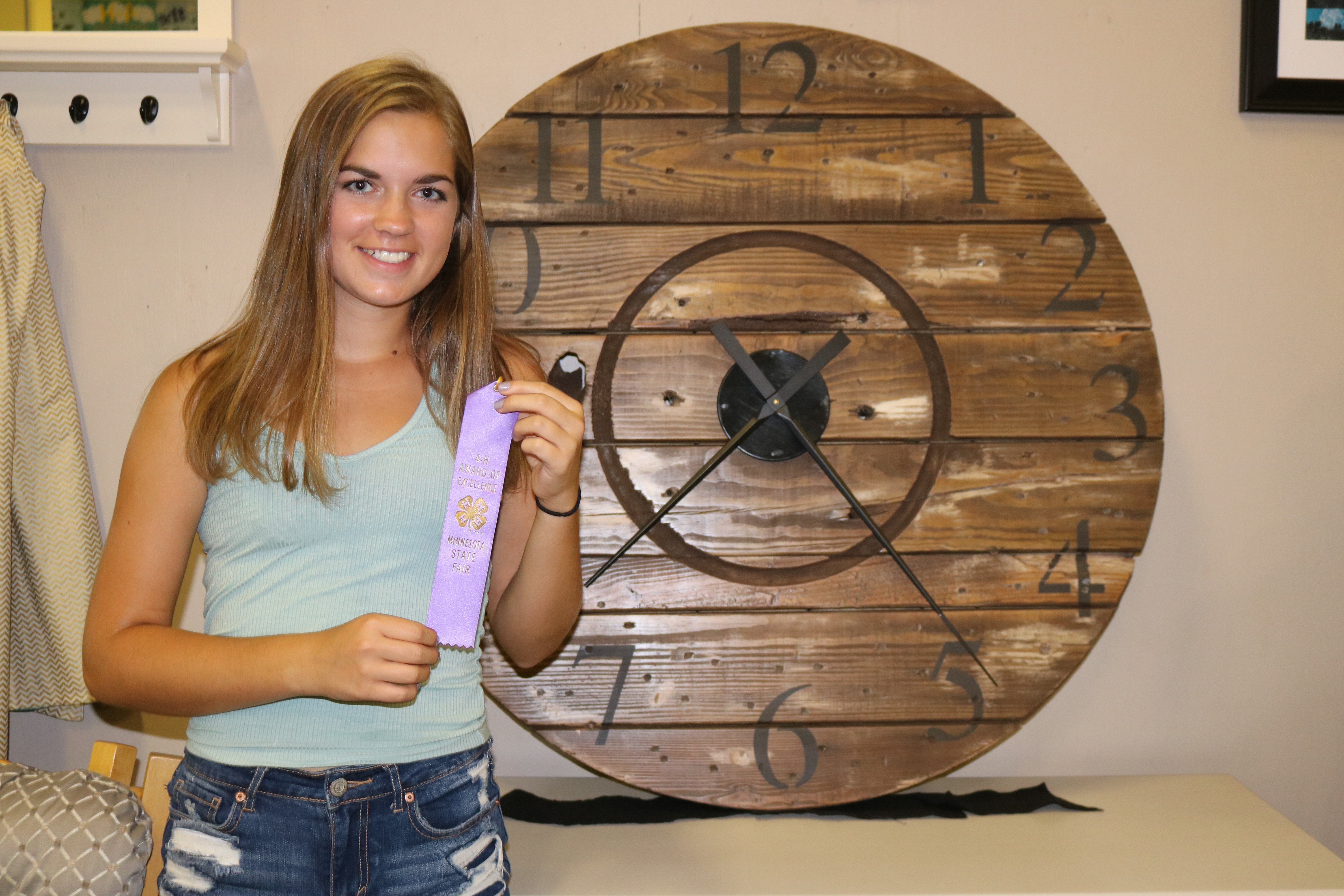 Paige Hanson of Kandiyohi county with her purple ribbon for home environment project.