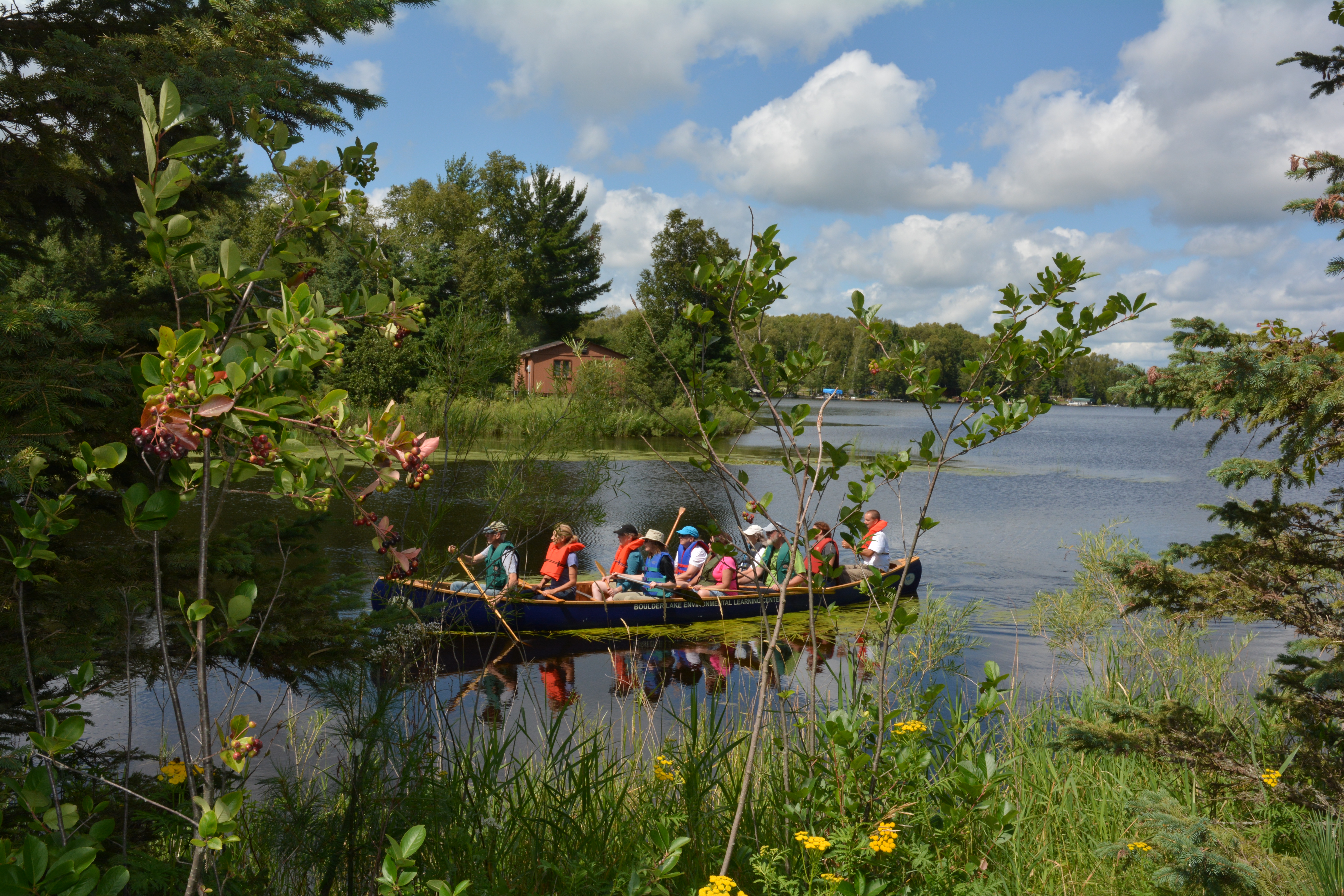 A group of people in a canoe on a lake.