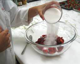 Adding sugar to berries.