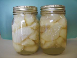 Two jars of canned apples.
