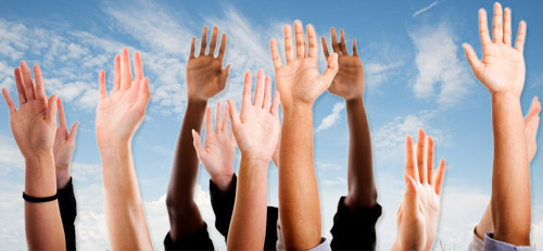 Arms of diverse group of people with hands up