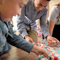 Two kids working together on a quilt
