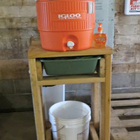 Handwashing stand built of lumber with drinking water cooler used as water dispenser