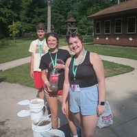 4-H camp counselors setting up a science activity