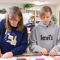 woman and teen work on a quilt