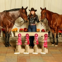 Rhiannan A. posing with two horses, trophies and ribbons