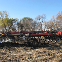 a disk ripper plow which has three rows of disks facing opposite directions and two rows of tines in between the disks.