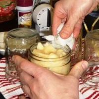 Cleaning rim of jar with clean cloth.