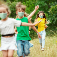 Kids running with masks on.