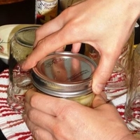 Adding lid and screw band to jar