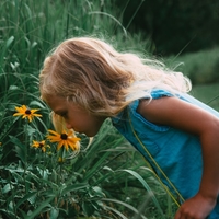Girl sniffing flowers