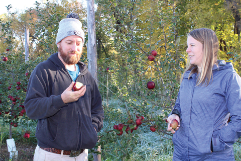 Annie Klodd in orchard talking with cider maker