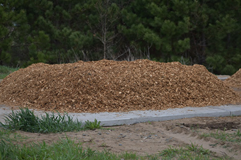 Wood chip base layer of compost pile