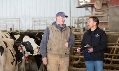 Jim Salfer with dairy farmer and cows