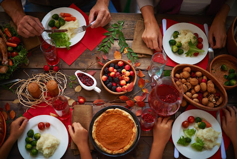 High angle view of a festive table and people eating.
