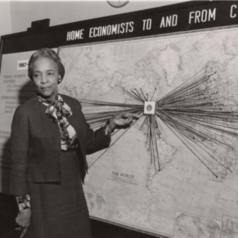 Flemmie Pansy Kittrell in front of a map with strings going to dozens of locations