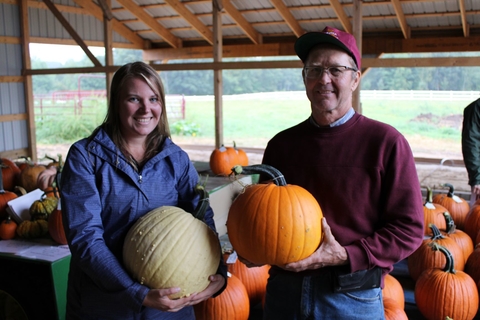 Annie Klodd with Rod Elmstrand holding pumpkins