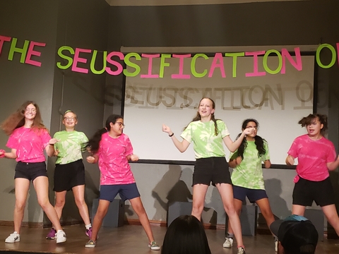 Girls performing a musical on a stage