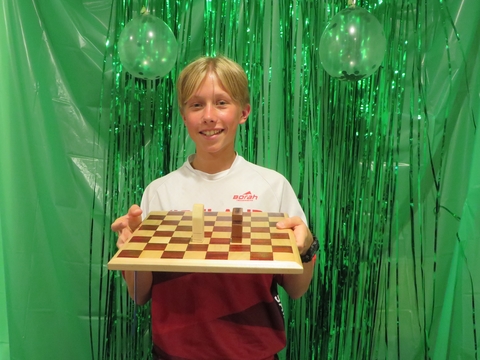 Boy holding self-made chess board