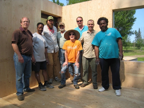 Group of adults who helped build the house frame.