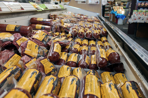 A grocery case full of packaged meat of different types, mostly bologna or sausage.