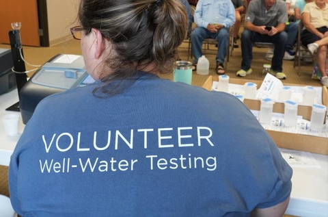 Back of t-shirt that says "VOLUNTEER Well-Water Testing".