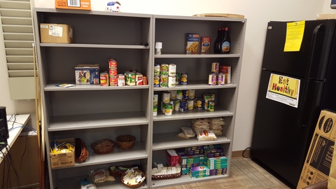 A messy area with food placed randomly on shelves