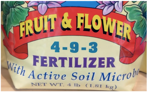Fruit and flower fertilizer bag with "4-9-3 fertilizer with active microbes" printed on the bag.