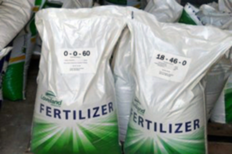 Two large bags labeled "Fertilizer". The one on the left has a label that reads "0-0-60." The other one reads, "18-46-0" indicating their amounts of nitrogen, phosphorus and potassium. 