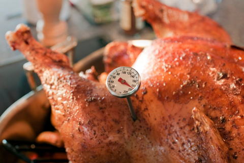 Turkey with food thermometer inserted.