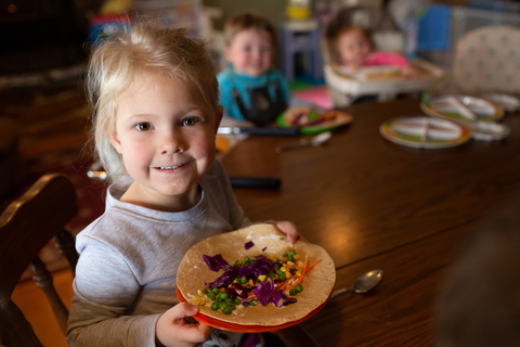 Young girl with colorful plate of vegetables