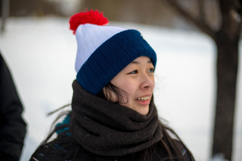 person in snow with winter hat on
