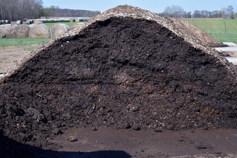 Inside of a finished compost pile showing dark, rich soil with no evidence of the carcass.