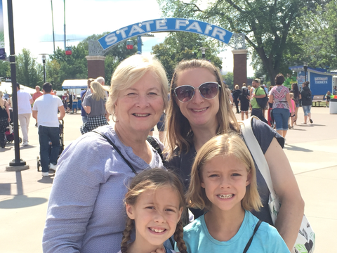 Martha Metz and her daughter and two granddaughters in front of Minnesota State Fair arch