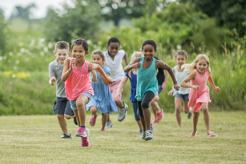 A group of kids running outside
