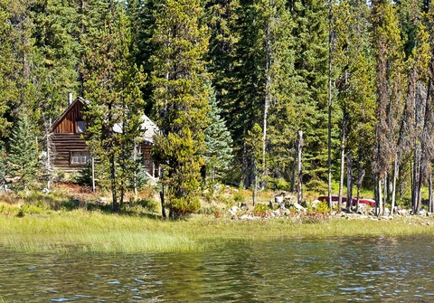 Rustic cabin on natural shoreline lake.