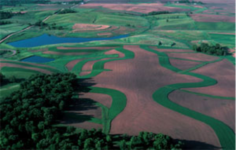 aerial photograph of farmfields and a lake