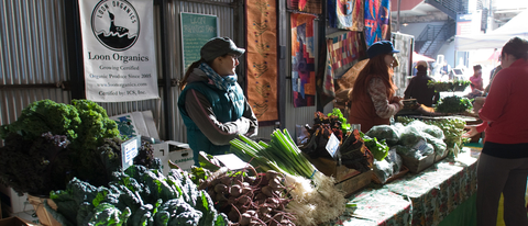 Woman selling vegetables at a farmer's market