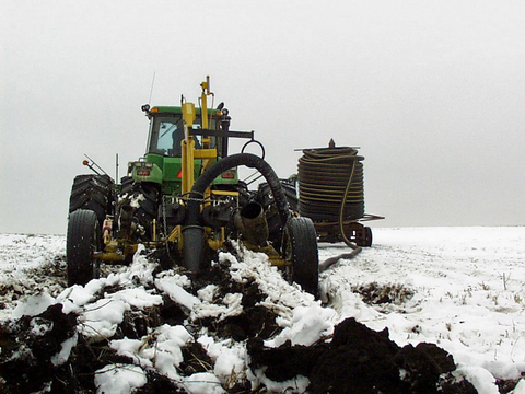 Tractor-mounted tile drainage plow