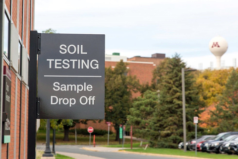 St. Paul campus scene featuring the sign outside the soil testing lab. The sign reads, "Soil testing. Sample drop off."